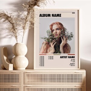 May include: A vintage-style album cover featuring a woman with red hair holding a bouquet of white flowers. The album title is "ALBUM NAME" and the artist name is "ARTIST NAME". The album was released in 2024.