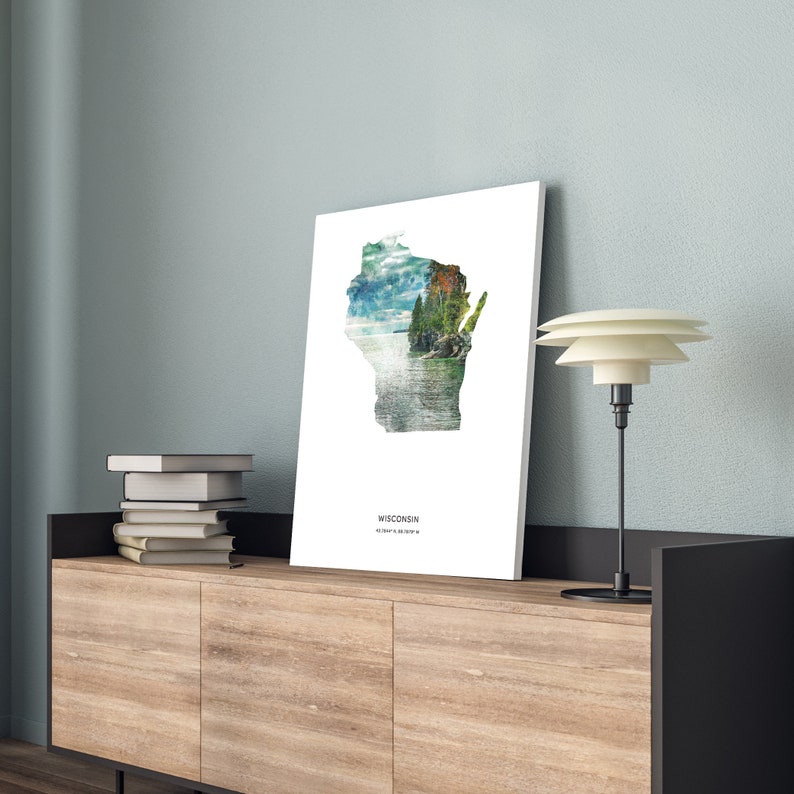 May include: A white print with a watercolor image of the state of Wisconsin. The image is a silhouette of the state with a landscape scene inside. The text "WISCONSIN" is printed below the image.