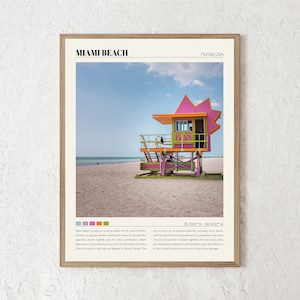 May include: A colorful lifeguard stand on a sandy beach in Miami Beach, Florida. The stand is painted pink, green, and orange. The text "Miami Beach" and "Florida, USA" is printed at the top of the image. The coordinates "25.7907&deg;N 80.1300&deg;W" are printed at the bottom of the image.