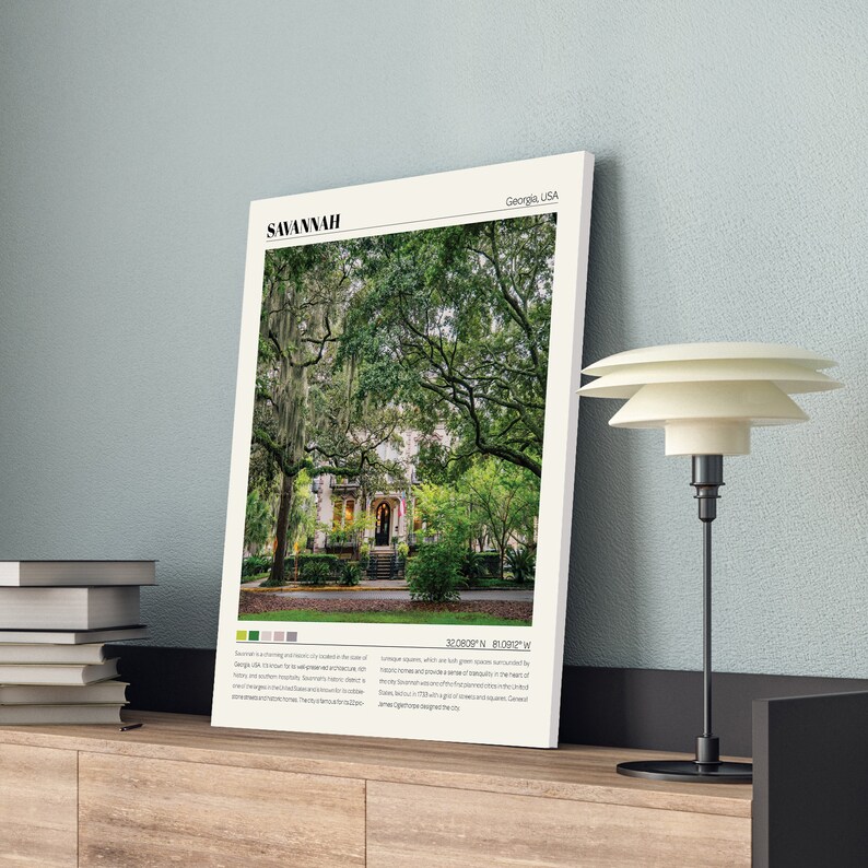 May include: A framed print of a house with a green lawn and trees in Savannah, Georgia, USA. The print includes the text "SAVANNAH" and the coordinates "32.0809&deg; N, 81.0997&deg; W".