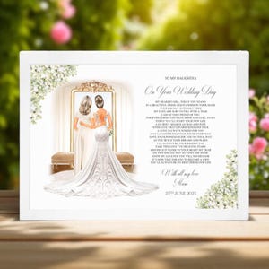 May include: A white framed print with a wedding theme. The print features an illustration of a bride and her mother, a poem, and the date "25th June 2025". Floral accents frame the text and illustration.