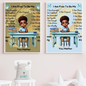 May include: Two motivational posters with a blue background and a brown background. Both posters feature a young boy sitting at a desk with books. The text on the posters reads "I Am Free To Be Me" and includes a list of positive affirmations. The posters are framed in white.