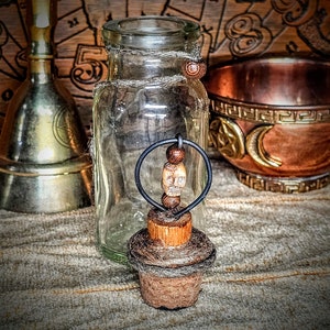 Antique apothecary bottle with decorative topper