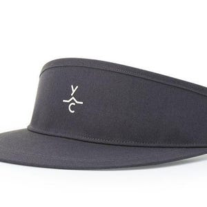 May include: A dark gray visor with a white logo that says "YXC" on the front.
