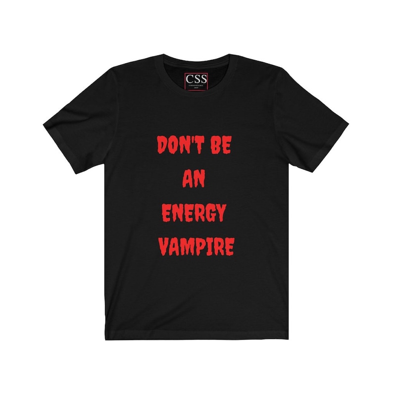 May include: Black t-shirt with the text "DON'T BE AN ENERGY VAMPIRE" in red.