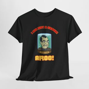 May include: Black t-shirt featuring a cartoon image of Richard Nixon in a glass jar, with the text "I AM NOT A CROOK!" above and "AROO!" below. The design is in red and yellow.