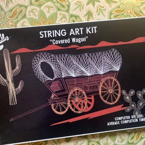 May include: String art kit featuring a covered wagon design. The kit includes all the materials needed to create a 11 inch by 18 inch string art piece. The average completion time is 8 hours.