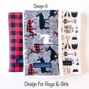 May include: Three fabric burp cloths with different designs. The first cloth is red and black plaid. The second cloth has a gray background with black and white deer silhouettes and red and black plaid accents. The third cloth has a white background with a brown beard, arrows, and the text "Wild & Free".