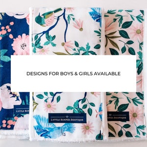 May include: Three fabric burp cloths with different floral and bird patterns. The cloths are white with blue, green, and pink accents. The text "Designs for boys & girls available" is displayed on a white banner.