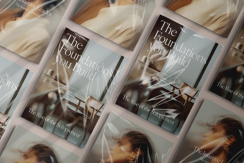 May include: Multiple copies of a book titled "The Foundations You Build" are displayed. The book cover features a minimalist interior design image and the text "The Rise of the Solopreneur". The book is wrapped in clear plastic.