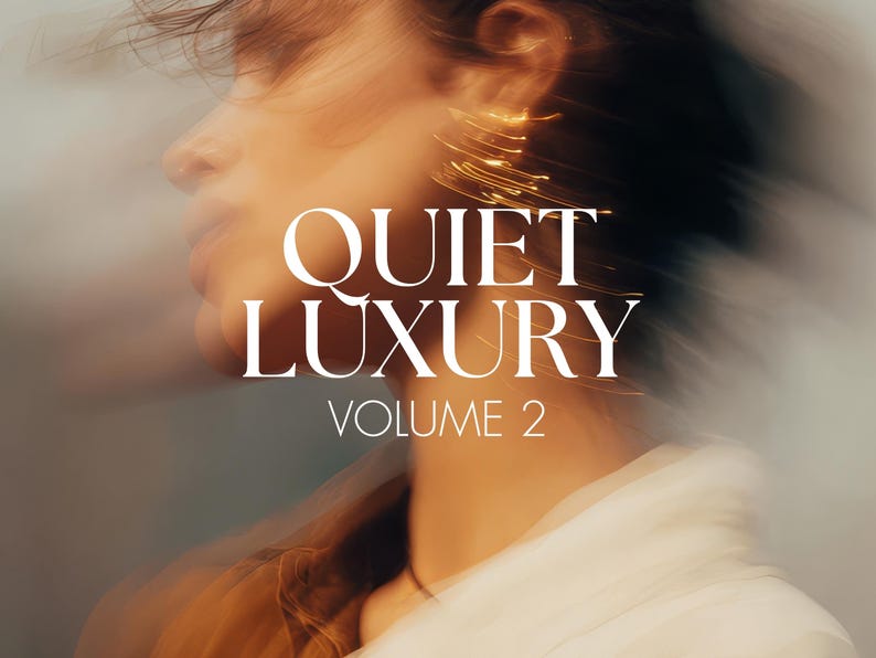 May include: An artistic image featuring the text "QUIET LUXURY VOLUME 2" in white, overlaid on a blurred portrait of a person. The person's profile is visible, with a focus on the ear adorned with gold earrings. The background has a soft, warm color palette.