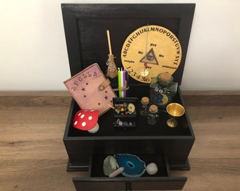 Witch’s Altar Box with Mini-Me miniature altar box. Each include moon water bottle, besom, spell book, spell candles, chalice and more !