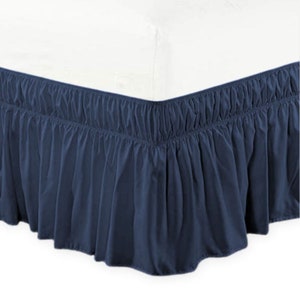 May include: A navy blue bed skirt with a ruffled edge. The skirt is made of a soft, wrinkle-resistant fabric and is designed to hide the box spring and create a more polished look for the bed.