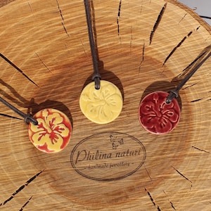 Summery ceramic necklace with hibiscus flower in yellow and red tones