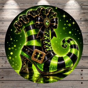 May include: A circular graphic featuring a high-heeled boot with a curled toe, decorated in alternating black and bright green stripes. The boot includes a black ruffled cuff, a black bow with a central green gem, and a gold buckle on the side.