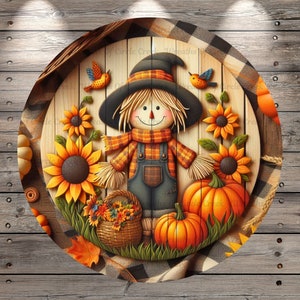 May include: A round wooden sign with a scarecrow, sunflowers, pumpkins, and fall leaves. The scarecrow is wearing a black hat, a plaid shirt, and blue overalls. The sign has a checkered background.