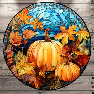 May include: A round stained glass design featuring two pumpkins and autumn leaves in shades of orange, yellow, and brown. The background is a mosaic of blue glass, and the design is framed by a dark border. The text "Circle Creek Wonders" is visible.