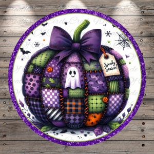 May include: A round Halloween-themed design featuring a patchwork pumpkin in shades of purple and green, adorned with a purple bow and a tag that reads "Spooky Season!". A friendly ghost is in the center.