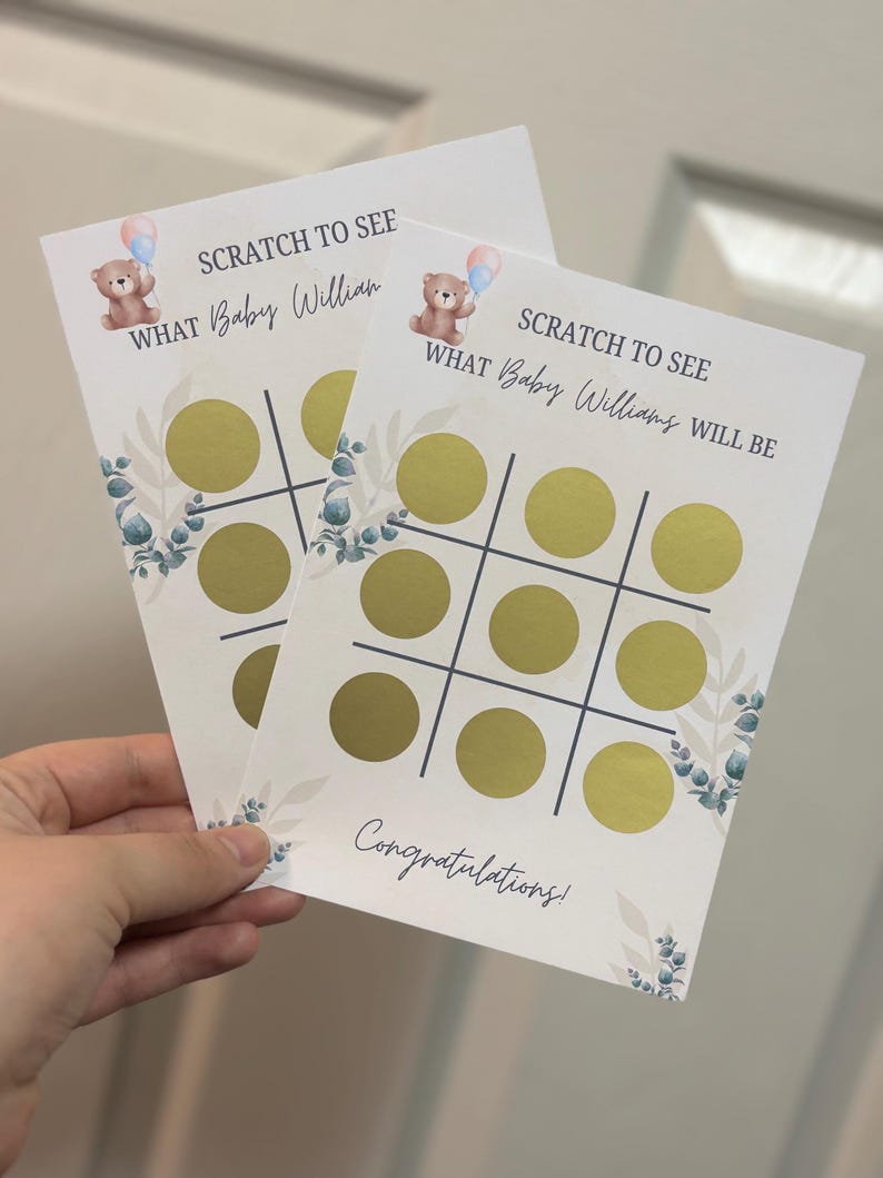 May include: Two baby shower scratch-off cards with a tic-tac-toe grid and gold scratch-off circles. The cards feature a teddy bear with balloons and the text "SCRATCH TO SEE WHAT Baby Willian/Williams WILL BE". The cards also say "Congratulations!"