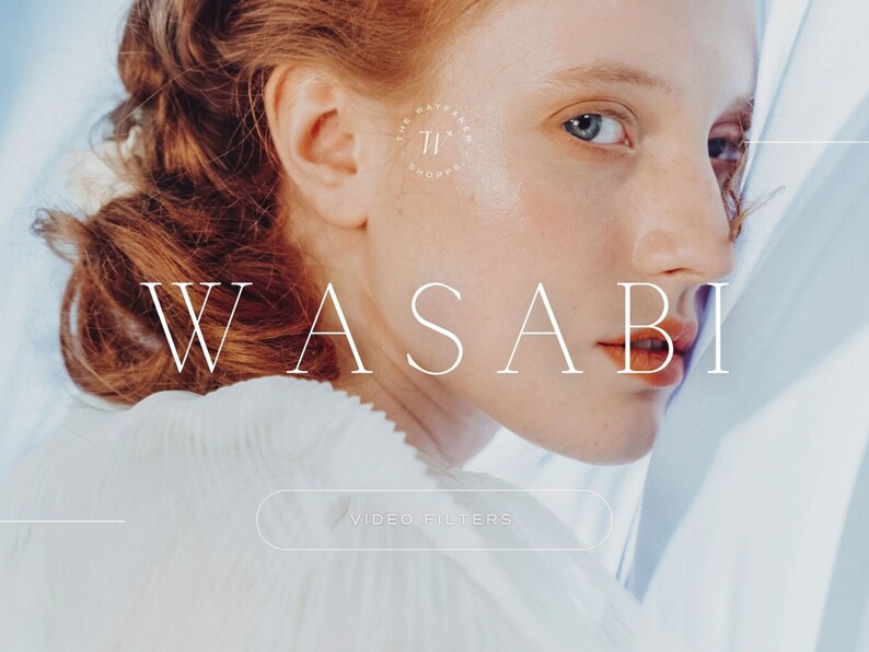 May include: A close-up of a woman's face with red hair, looking over her shoulder. The text "WASABI" is in white letters against a light blue background. The text "VIDEO FILTERS" is in a white button.