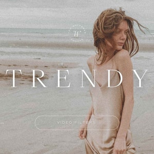 May include: A woman in a beige dress stands on a beach with the text "TRENDY" and "VIDEO FILTERS" on the image. The image has a vintage filter applied.
