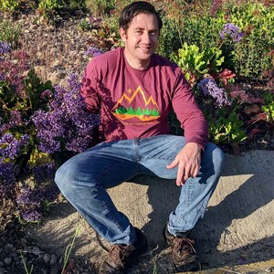Man wearing a dog dad long sleeve hiking shirt