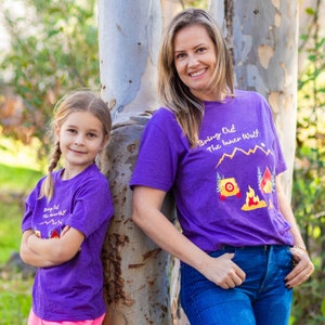 Mother and her daughter posing in matching purple dog lover shirts with camping graphics