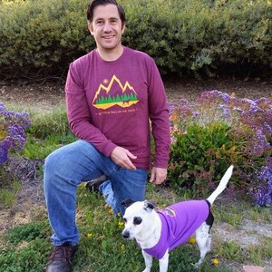 Man and a small dog wearing long sleeve, matching dog and owner hiking shirts from Fetch The Sun