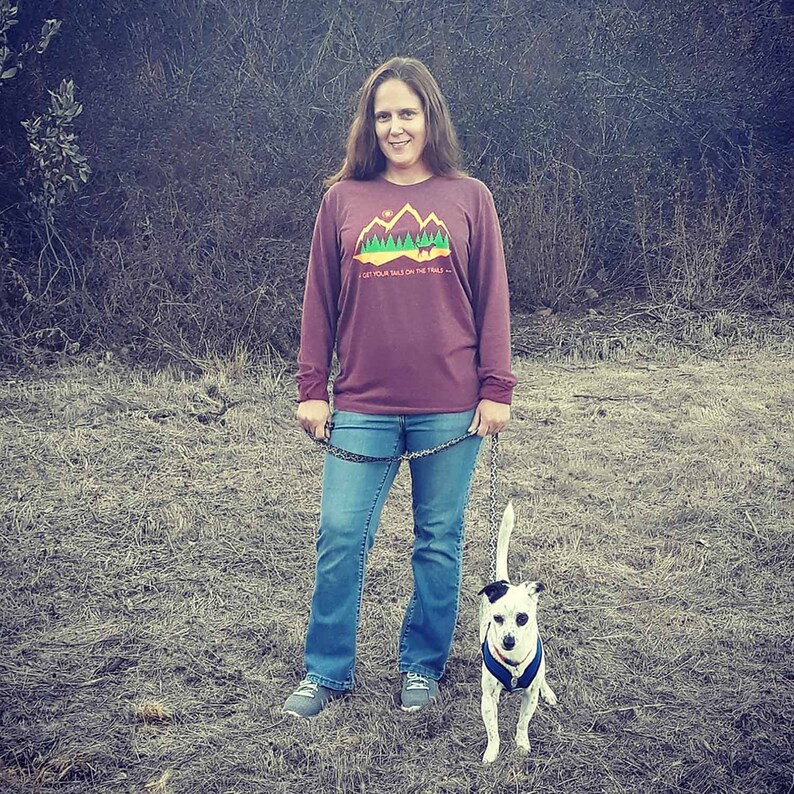 Woman walking her dog and wearing a dog mom hiking shirt with long sleeves