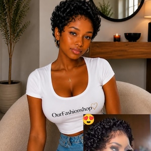 May include: A short black wig with tight curls and a lace front base. The wig features a natural-looking hairline and dense, coiled texture. An inset image shows the lace front detail clearly, highlighting the construction of the hairpiece.