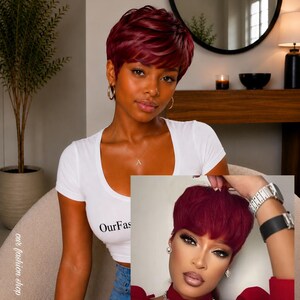 May include: A short, layered wig in a deep burgundy red color. The hair is styled in a textured pixie cut with soft, voluminous layers throughout the crown and fringe, creating a natural look with a consistent dark red tone across the entire style.