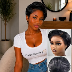 May include: A short, black, layered pixie cut wig with a side part. The hair is straight and styled with volume at the crown, tapering toward the nape of the neck. The wig features a lace front construction, shown from the front and back angles.