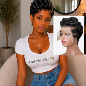 May include: A short black pixie cut wig with defined curls and a transparent lace front. The wig features a textured, layered style with a natural hairline. An inset image shows the wig on a mannequin head, highlighting the lace construction.