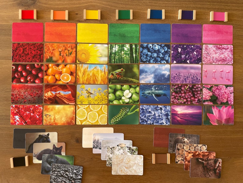 May include: A set of colorful cards featuring various nature scenes, including flowers, fruits, and landscapes. The cards are arranged in a rainbow pattern, with each color represented by a different card. The cards are perfect for teaching children about colors and nature.
