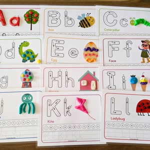 May include: A set of 12 alphabet tracing cards featuring uppercase and lowercase letters with corresponding images and words. Each card has a dotted line for tracing the letter and a space for the child to practice writing the letter.
