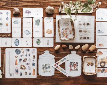 May include: A set of educational materials for teaching fractions using colourful illustrations of rocks and gems. The set includes fraction cards, a 100 grid, a jar with stickers, and a worksheet with a truck and rocks.