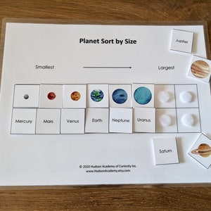 May include: A printable educational activity for kids to learn about the planets in our solar system. The activity includes a chart with the names of the planets and a set of cards with images of the planets. The cards are labeled with the names of the planets and can be sorted by size from smallest to largest. The activity is titled "Planet Sort by Size".