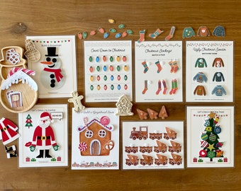 May include: A set of ten printable Christmas activity cards for kids. The cards feature activities like building a snowman, counting down to Christmas, matching Christmas sweaters, and decorating a Christmas tree. The cards are printed on white cardstock and have colorful illustrations.
