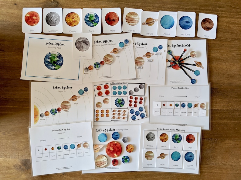 May include: A set of printable solar system learning activities for kids. The set includes a solar system model, planet counting, planet sort by size, and solar system name matching. The activities feature watercolor illustrations of the planets and the sun.