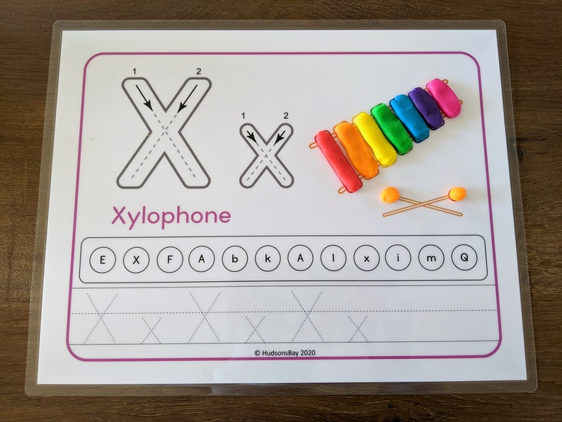 May include: A printable worksheet for learning the letter X. The worksheet features a picture of a xylophone with the word "Xylophone" written below it. The letter X is shown with arrows indicating the direction to trace the letter. There are also practice lines for tracing the letter X.