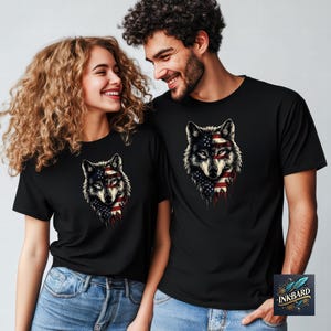 a man and a woman wearing black t - shirts with wolf heads on them
