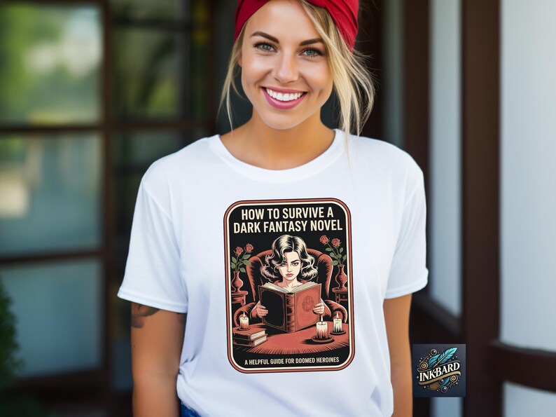 A smiling woman wearing a white t-shirt with a graphic design of a woman reading a book.