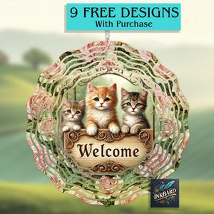 May include: A metal wind spinner with a layered design featuring pink roses and three kittens. The kittens are sitting on a sign that says "Welcome".