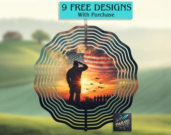 May include: A metal wind spinner with a silhouette of a soldier saluting in front of an American flag. The background is a sunset with airplanes flying overhead. The text "9 FREE DESIGNS With Purchase" is at the top of the image.