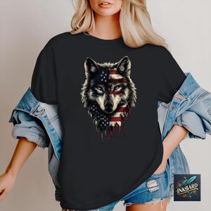 a woman wearing a black shirt with an american wolf on it