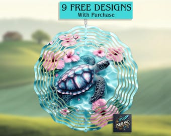 May include: A metal wind spinner with a blue and green design featuring a sea turtle swimming in a turquoise ocean with pink flowers. The wind spinner has a circular shape with multiple layers of metal.
