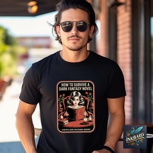 A man wearing a black t-shirt with a graphic design and text printed on it, standing in front of a brick building.