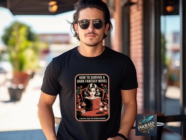 A man wearing a black t-shirt with a graphic design and text printed on it, standing in front of a brick building.
