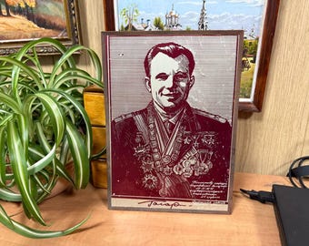 Yuri Gagarin the first cosmonaut. Vintage souvenir, portrait print on metal  1961, Earth satellite, space.