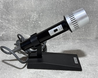 May include: A black and silver Sony microphone with a stand and a coiled cord. The microphone has a silver grill and a black body with the word "SONY" printed on it.